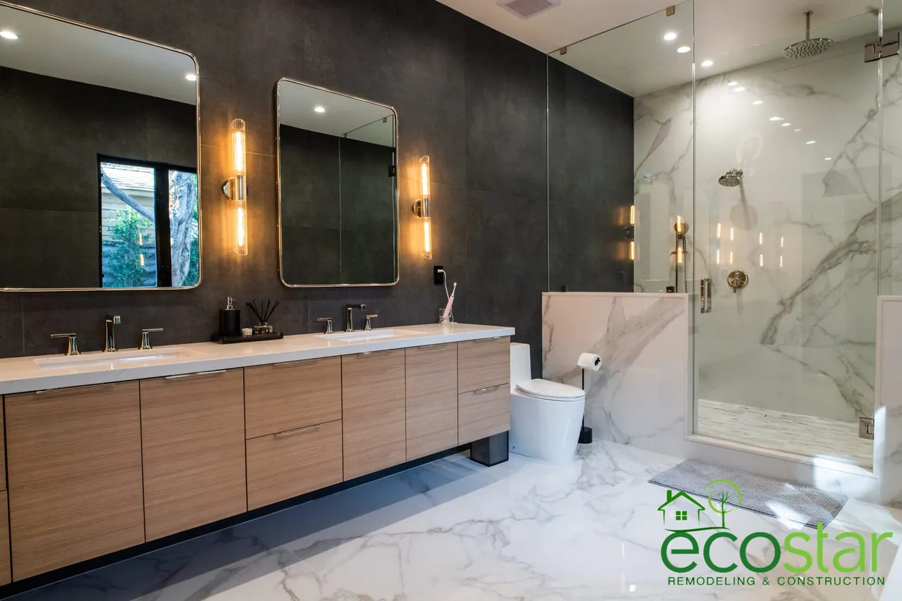 Bathroom remodel by EcoStar Remodeling & Construction: glass shower with marble-look tile walls, large dark wall tiles, floating wood vanity and a ceiling exhaust fan