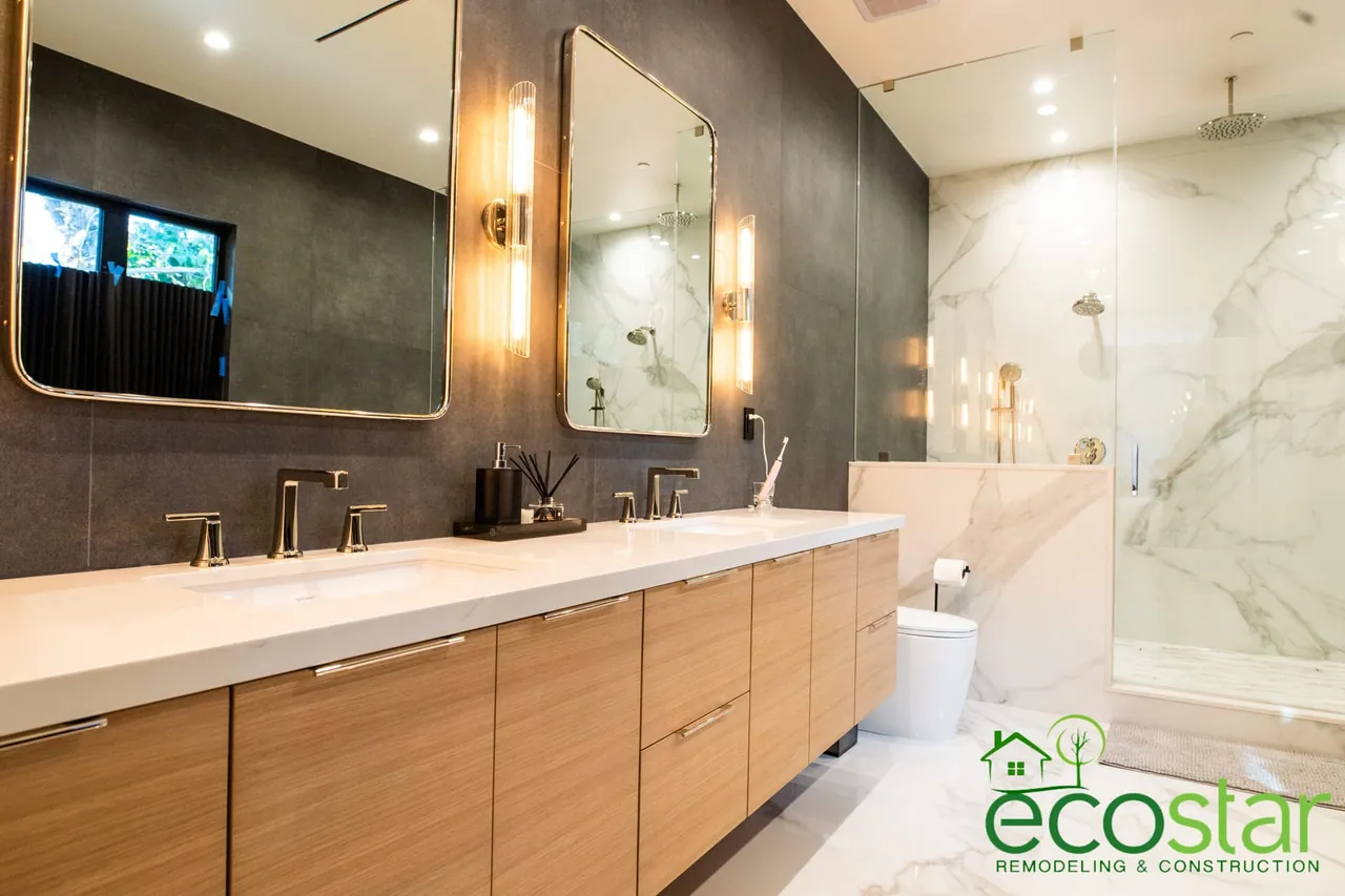 Floating double vanity with a stone-look top and undermount sinks in a bathroom remodeled by EcoStar Remodeling & Construction