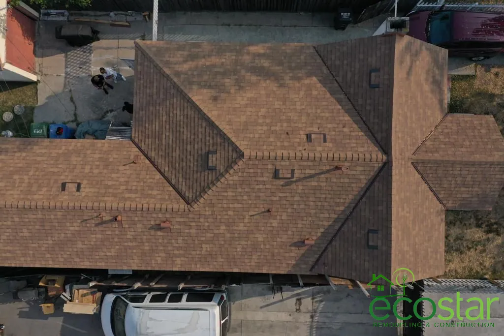 Top-down view of a shingle roof with hips, valleys and roof vents by EcoStar Remodeling & Construction
