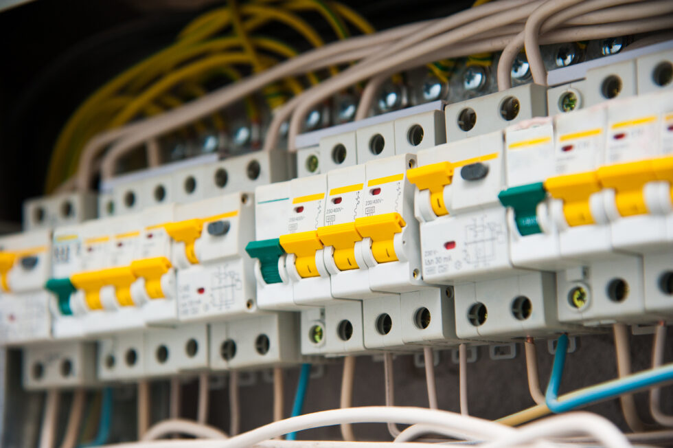 Circuit breakers and wiring inside an open electrical panel